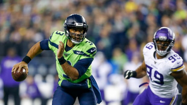 Seattle Seahawks quarterback Russell Wilson (3) scrambles out of the pocket against the Minnesota Vikings during the second quarter at CenturyLink Field.